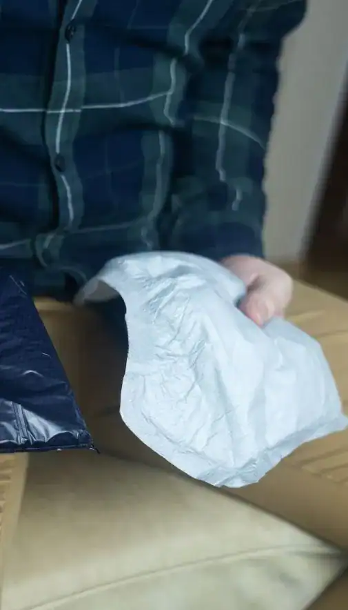 Image of man holding incontinence pads as part of overactive bladder treatment Liverpool