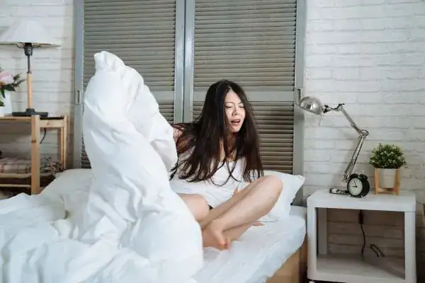 Image of woman getting up because of nighttime leaks Liverpool